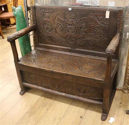 A 17th century style carved oak settle